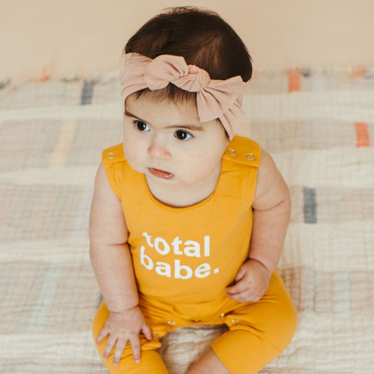 yellow total babe romper on beautiful baby