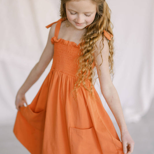crimson play dress with pocket and tie straps