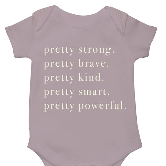 Pretty strong. Pretty Brave. Pretty kind. Pretty smart. Pretty powerful. Onesie in mauve.